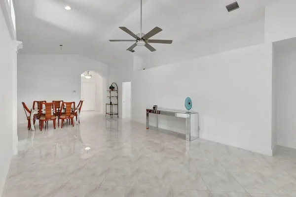 a view of a livingroom with furniture and a table chairs