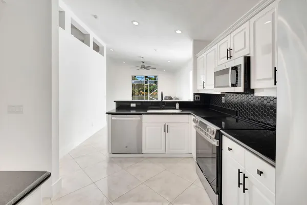 a kitchen with cabinets and appliances