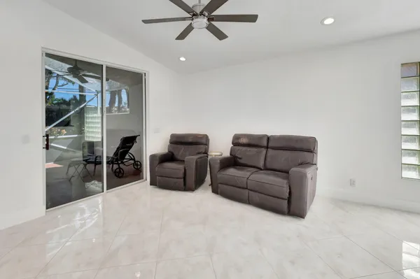 a living room with furniture and a ceiling fan
