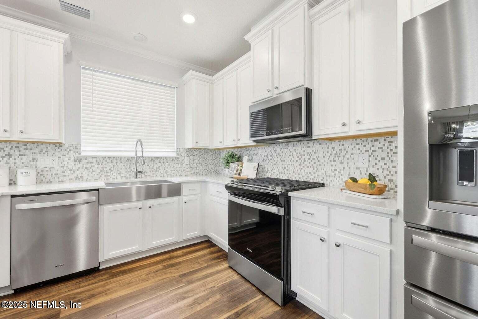 251 Rambling Brk Trail St. Johns, FL 32259 - Photo 13 of 40 a kitchen with granite countertop white cabinets and stainless steel appliances