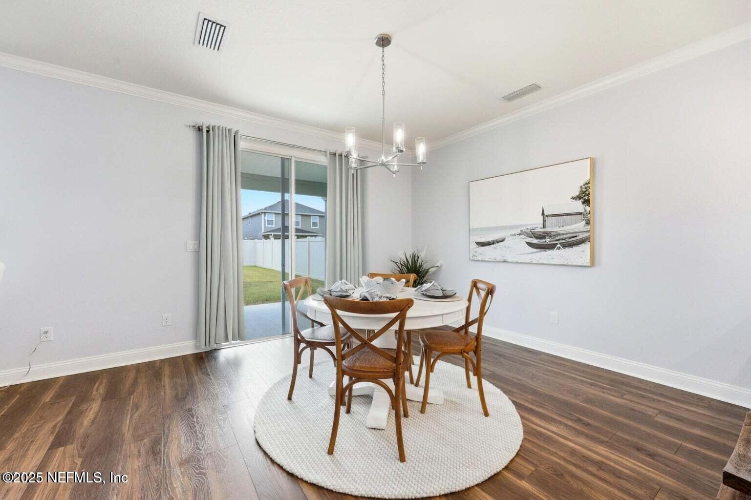 251 Rambling Brk Trail St. Johns, FL 32259 - Photo 17 of 40 a dining room with furniture a chandelier and wooden floor