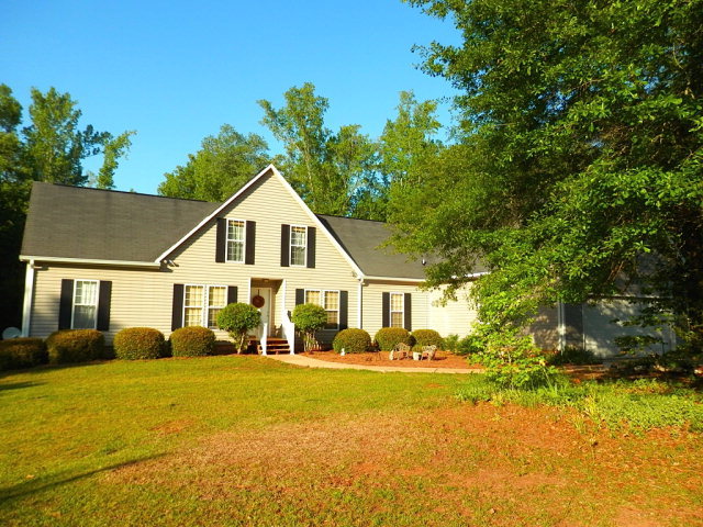 a front view of house with yard and green space