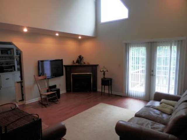 2091 Smith Road Forsyth, GA 31029 - Photo 11 of 13 a living room with furniture a fireplace and a flat screen tv