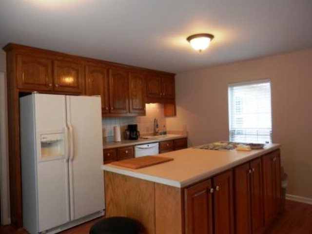 2091 Smith Road Forsyth, GA 31029 - Photo 12 of 13 a kitchen with a sink a refrigerator and cabinets