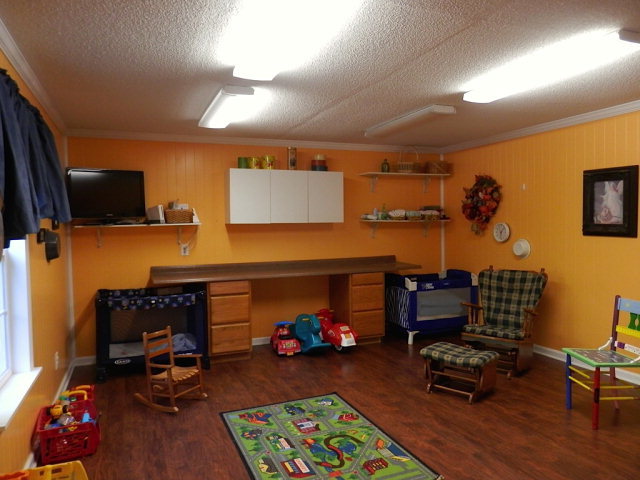 2091 Smith Road Forsyth, GA 31029 - Photo 3 of 13 a bedroom with furniture and a wooden floor