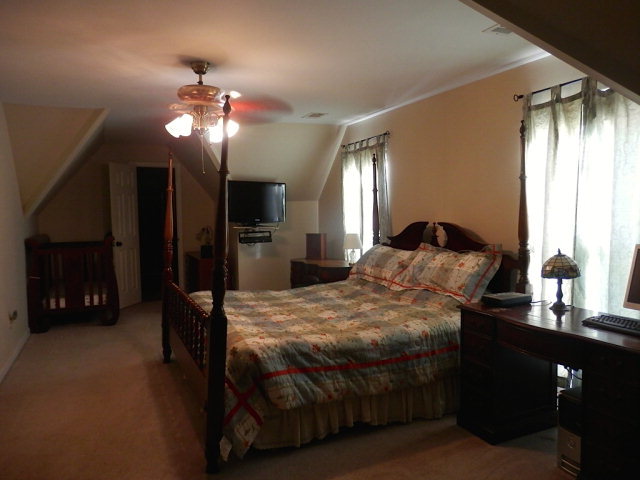 2091 Smith Road Forsyth, GA 31029 - Photo 4 of 13 a bedroom with a bed a mirror and lamp