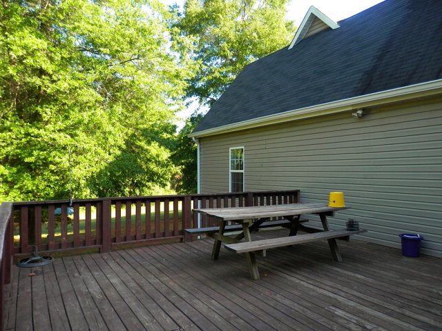 2091 Smith Road Forsyth, GA 31029 - Photo 5 of 13 a view of a wooden bench sitting on the roof deck