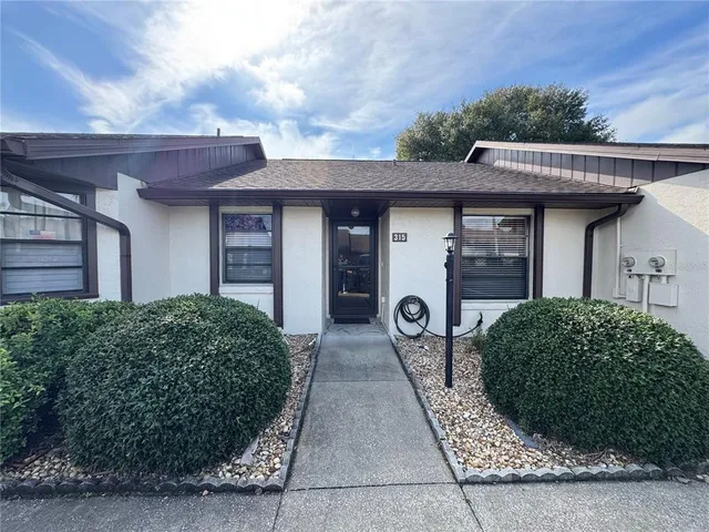 a front view of a house with garden
