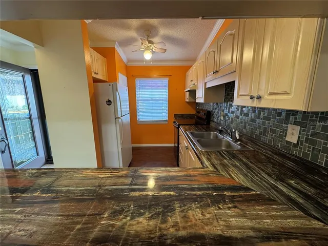 a view of a kitchen with wooden floor and staircase