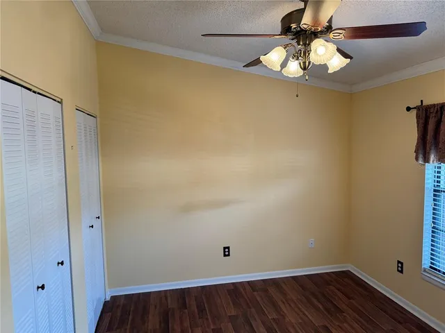a view of room with hardwood floor and ceiling fan