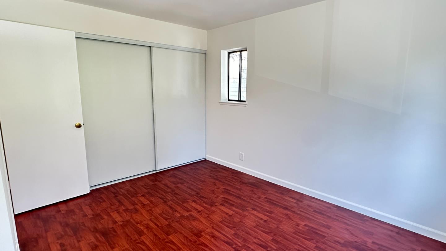 274 Stonegate Circle San Jose, CA 95110 - Photo 12 of 20 an empty room with wooden floor and windows