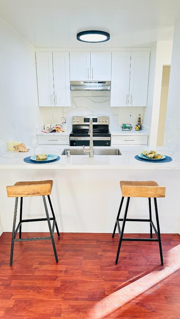 274 Stonegate Circle San Jose, CA 95110 - Photo 8 of 20 a kitchen with stainless steel appliances wooden floor and a stove top oven