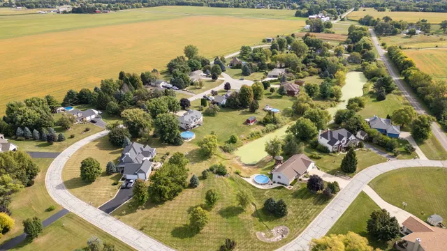a view of a swimming pool with outdoor seating and lake