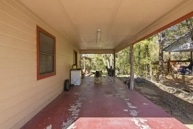 an aerial view of a city with lots of residential buildings ocean and mountain view in back