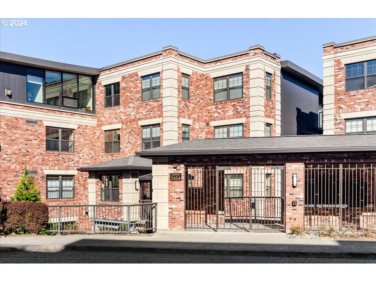 2454 Northwest Westover Road, Unit 5205 Portland, OR 97210 - Photo 1 of 33 a front view of a building with a garden