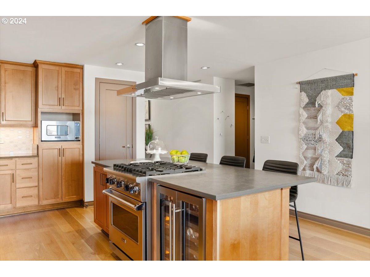 2454 Northwest Westover Road, Unit 5205 Portland, OR 97210 - Photo 15 of 33 a kitchen with stainless steel appliances granite countertop a stove a sink and a refrigerator