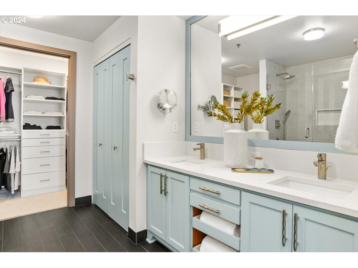 2454 Northwest Westover Road, Unit 5205 Portland, OR 97210 - Photo 20 of 33 a bathroom with a sink a mirror and a shower