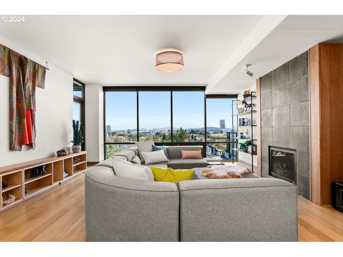 2454 Northwest Westover Road, Unit 5205 Portland, OR 97210 - Photo 4 of 33 a living room with fireplace furniture and a large window