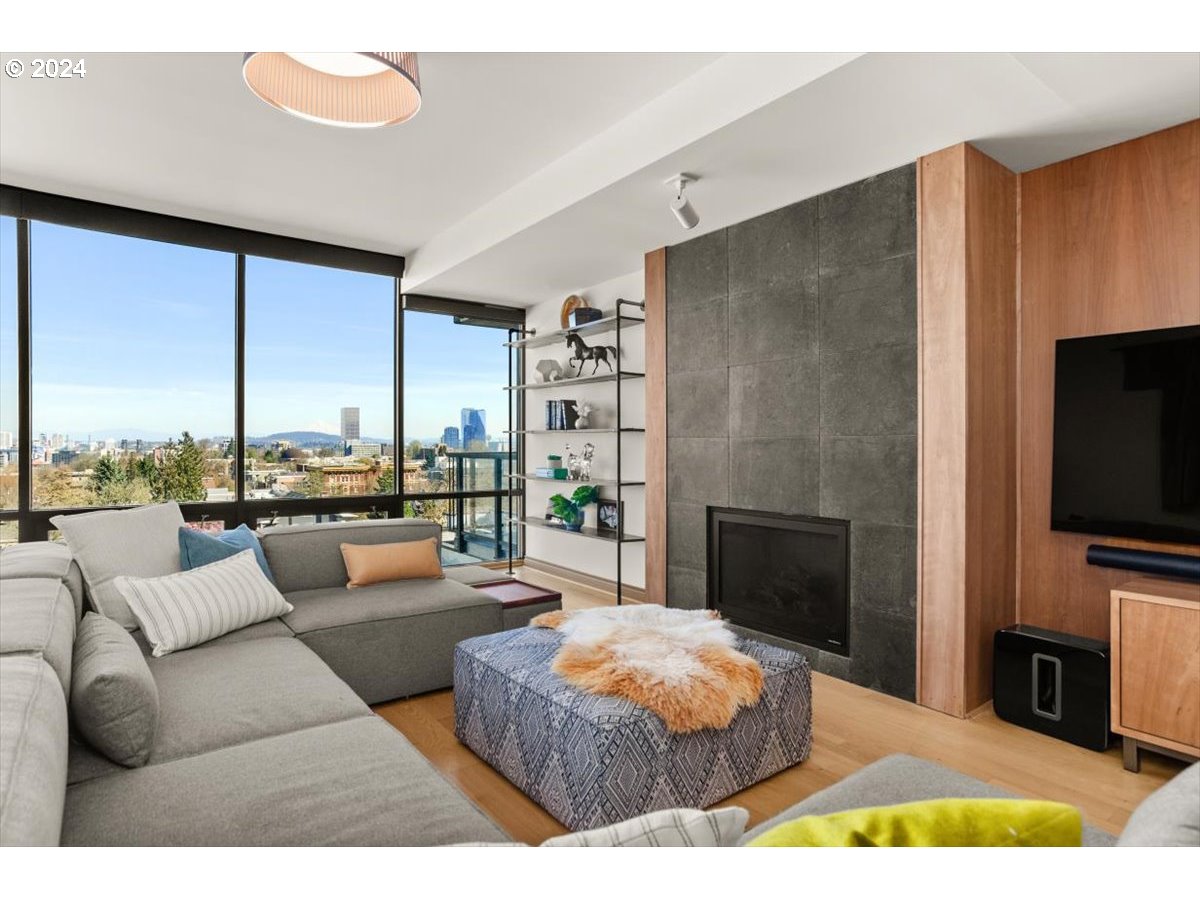 2454 Northwest Westover Road, Unit 5205 Portland, OR 97210 - Photo 6 of 33 a living room with fireplace furniture and a flat screen tv