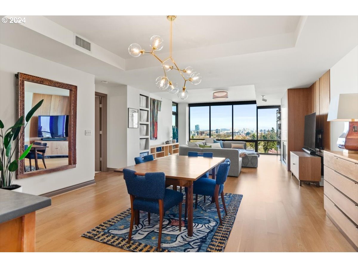 2454 Northwest Westover Road, Unit 5205 Portland, OR 97210 - Photo 8 of 33 a view of a dining room with furniture and wooden floor
