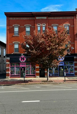 a view of a building and a people on a street