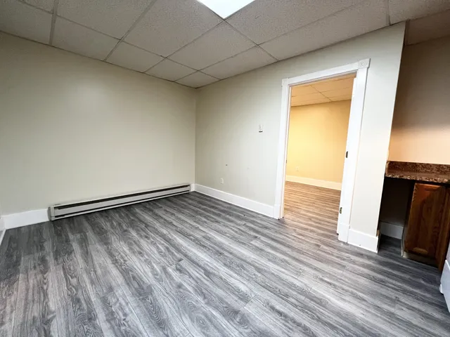 a view of a room with wooden floor