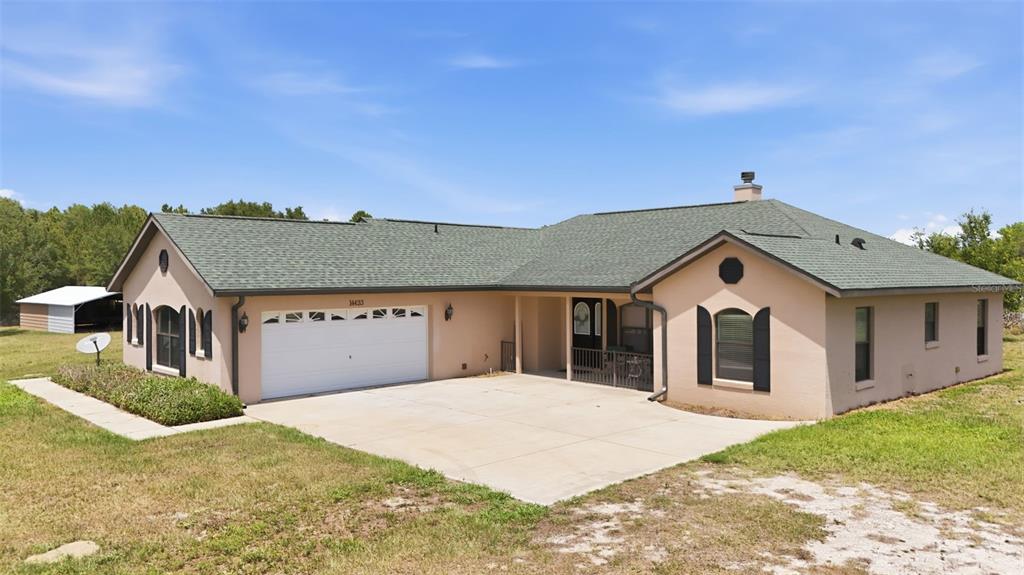 14433 Lake Yale Road Umatilla, FL 32784 - Photo 3 of 38 a front view of a house with a yard and garage