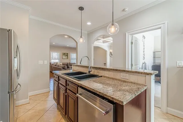 a kitchen with stainless steel appliances granite countertop a sink stove and refrigerator