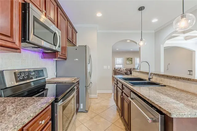 a kitchen with stainless steel appliances granite countertop a stove and a microwave