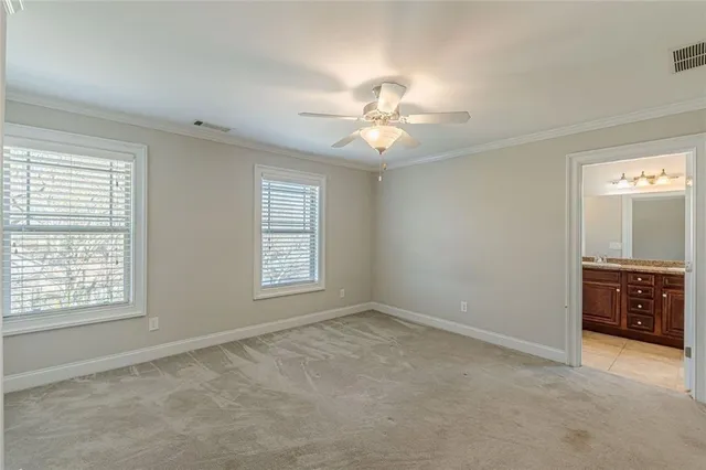 a view of an empty room and a ceiling fan