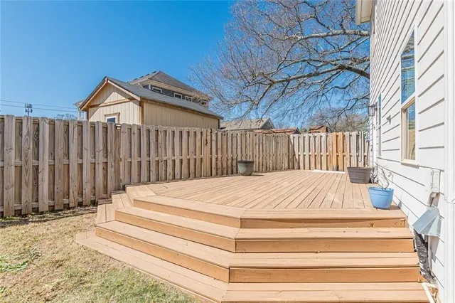 a view of a patio with wooden floor and fence