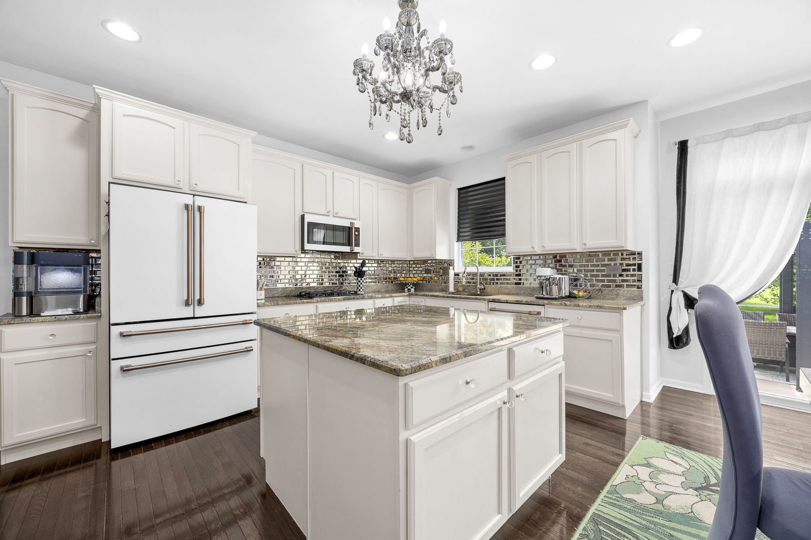 2297 Deerpath Road Bolingbrook, IL 60490 - Photo 13 of 46 a kitchen with kitchen island granite countertop a sink stove refrigerator and cabinets