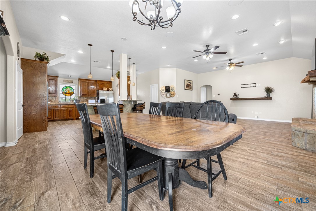 16101 Dove Road Moody, TX 76557 - Photo 13 of 42 a dining room with kitchen island furniture a chandelier and kitchen view