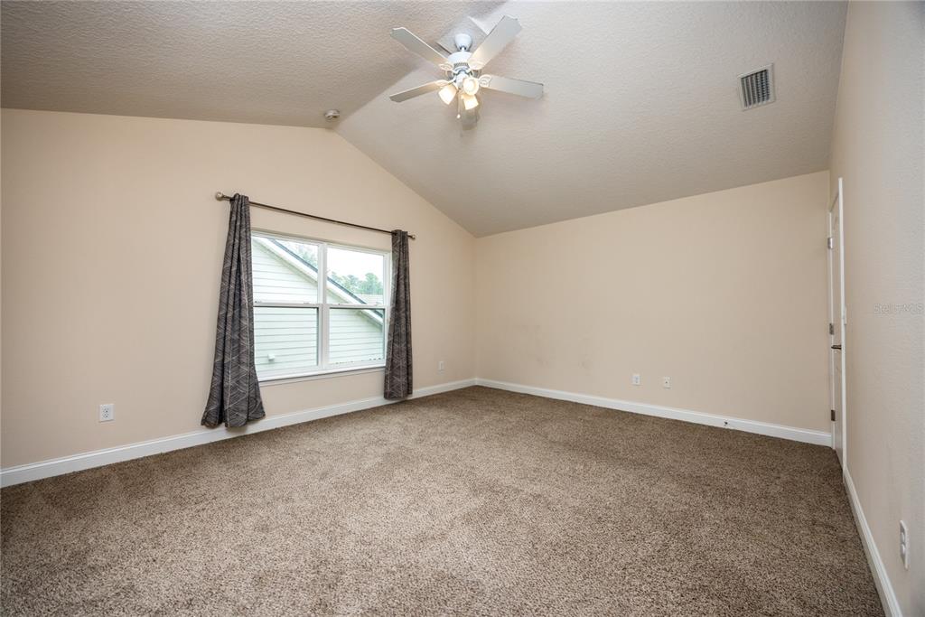 8216 Northwest 54th Street Gainesville, FL 32653 - Photo 46 of 58 an empty room with chandelier fan and windows