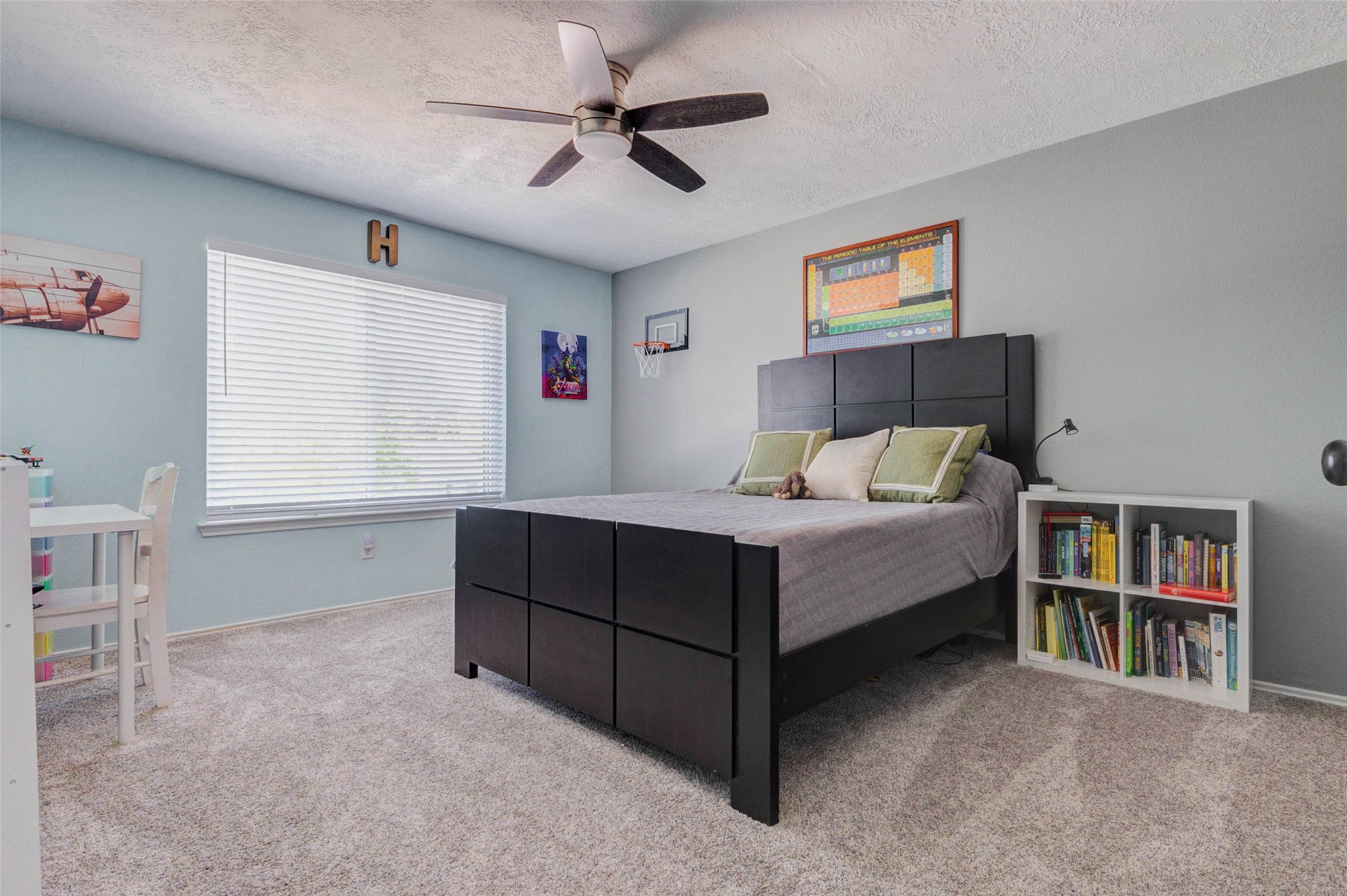 9215 Landry Boulevard Spring, TX 77379 - Photo 30 of 42 Guest bedroom one offers plush carpet, decorator paint, a ceiling fan, and a large window that fills the space with natural light while providing plenty of room for furniture and personal style.