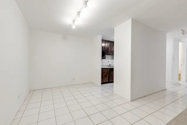 a kitchen with a stove cabinets and a refrigerator
