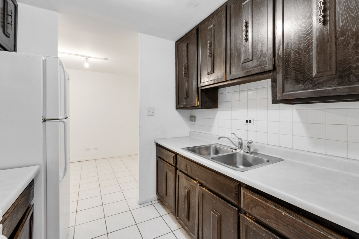 16 East Old Willow Road, Unit 202S Prospect Heights, IL 60070 - Photo 15 of 25 a kitchen with a sink stainless steel appliances and cabinets