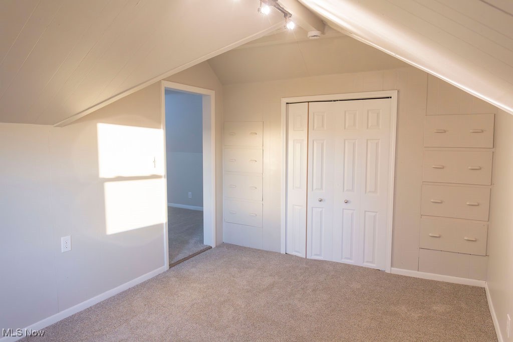 3448 Maple Road Jefferson, OH 44047 - Photo 19 of 25 Bonus room featuring carpet and vaulted ceiling