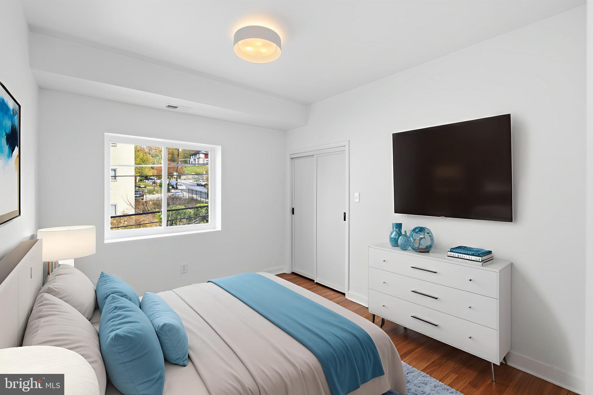 2834 R Street Southeast, Unit 6 Washington, DC 20020 - Photo 12 of 33 a bedroom with a bed and a flat screen tv