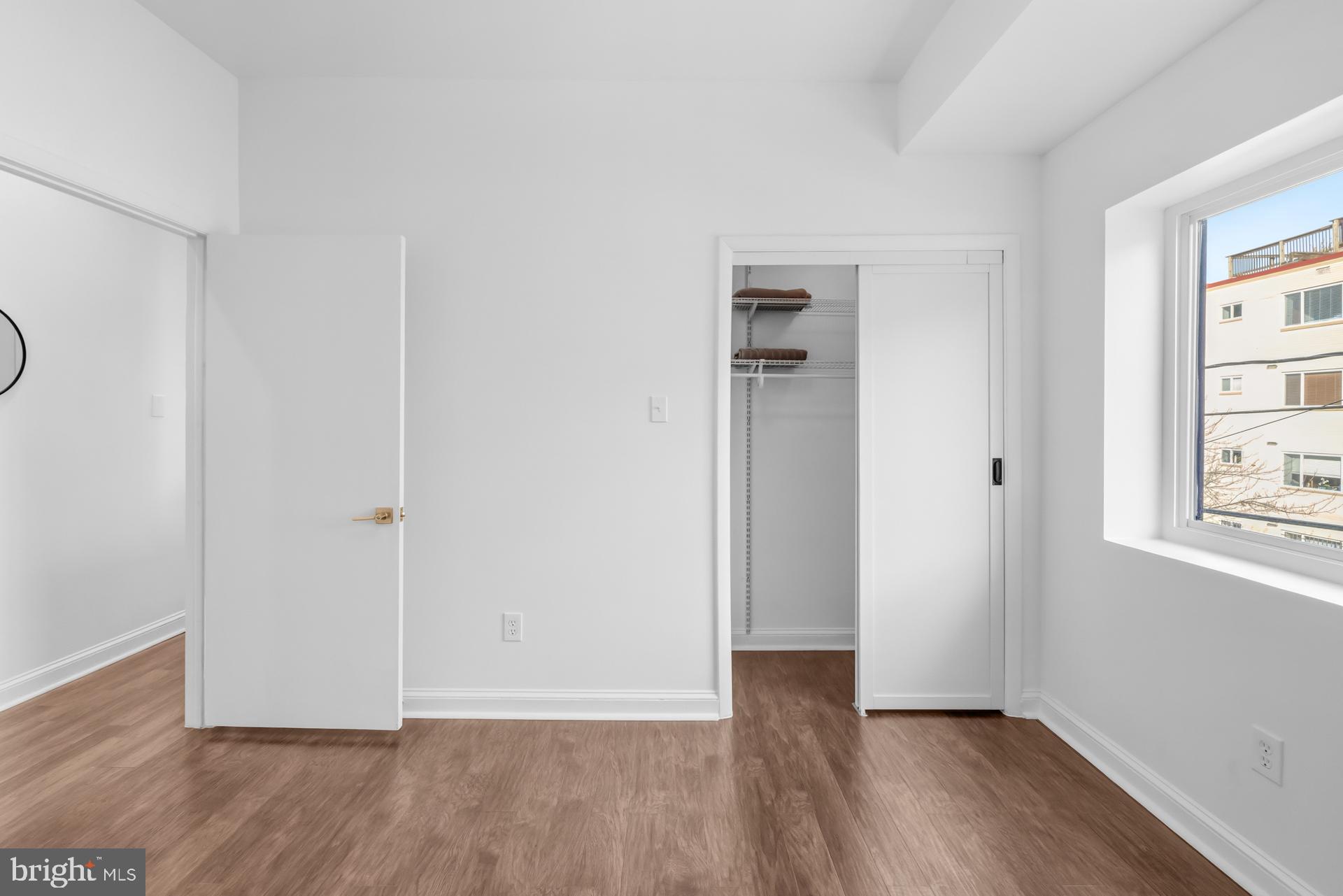 2834 R Street Southeast, Unit 6 Washington, DC 20020 - Photo 16 of 33 a view of an empty room with wooden floor and a window