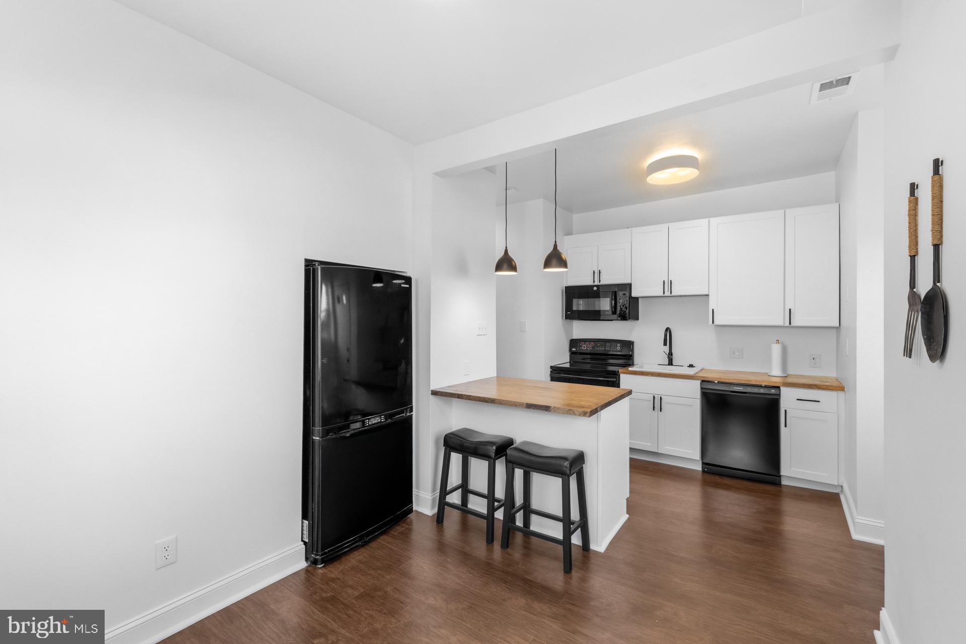 2834 R Street Southeast, Unit 6 Washington, DC 20020 - Photo 25 of 33 a kitchen with a refrigerator and a stove top oven