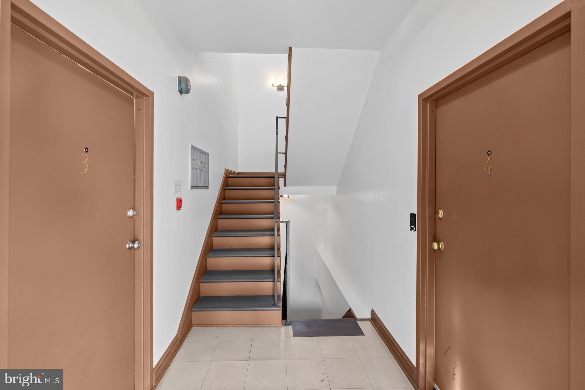 2834 R Street Southeast, Unit 6 Washington, DC 20020 - Photo 4 of 33 a view of a hallway with staircase and white walls