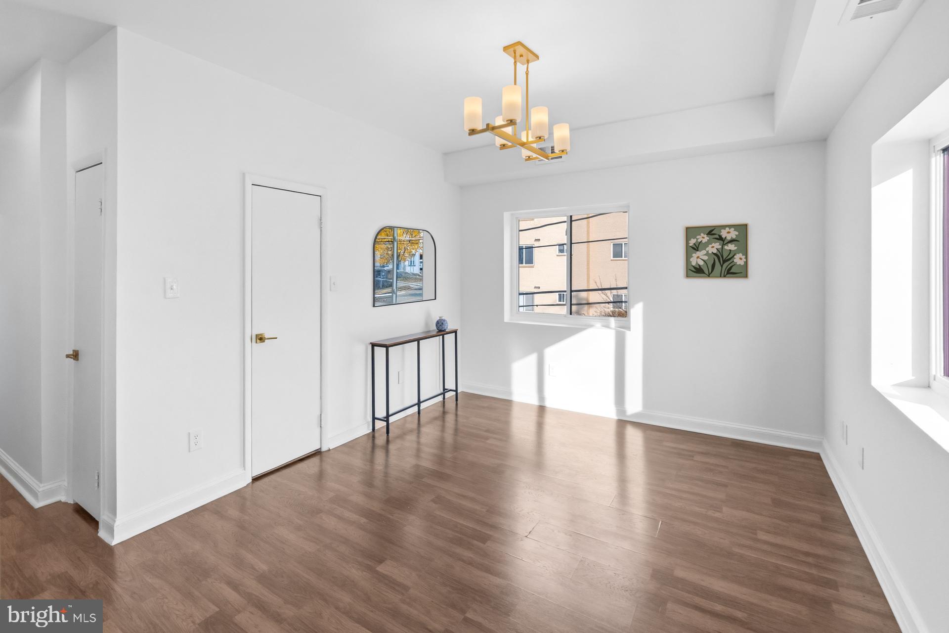 2834 R Street Southeast, Unit 6 Washington, DC 20020 - Photo 6 of 33 a view of an empty room with a window and wooden floor