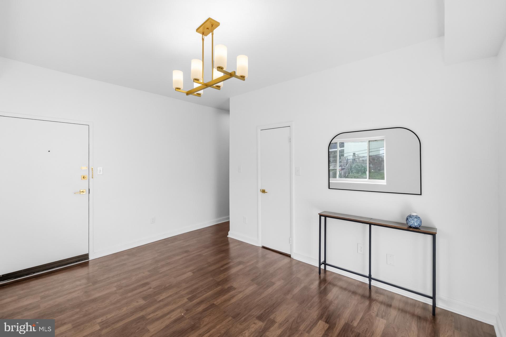 2834 R Street Southeast, Unit 6 Washington, DC 20020 - Photo 7 of 33 a view of a hallway with wooden floor and a chandelier