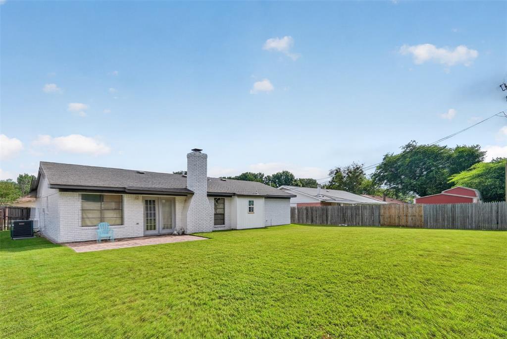 1212 Manning Road Benbrook, TX 76126 - Photo 16 of 20 Expansive green lawn with a white brick exterior and a privacy fence