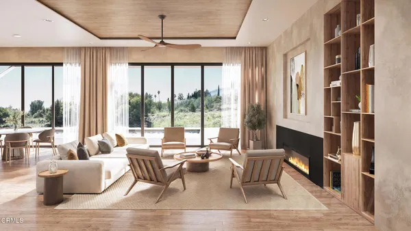 a living room with couches a coffee table and a large window with outer view