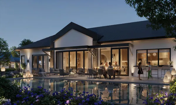 a front view of a house with lake view and outdoor seating