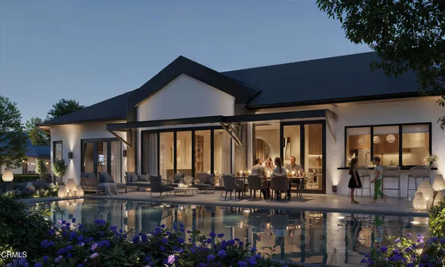 a front view of a house with lake view and outdoor seating