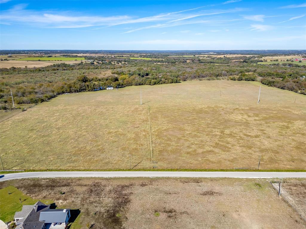 0 County Road 410 Road Alvarado, TX 76009 - Photo 3 of 12 Expansive acreage featuring open fields, mature tree lines, and a paved road frontage