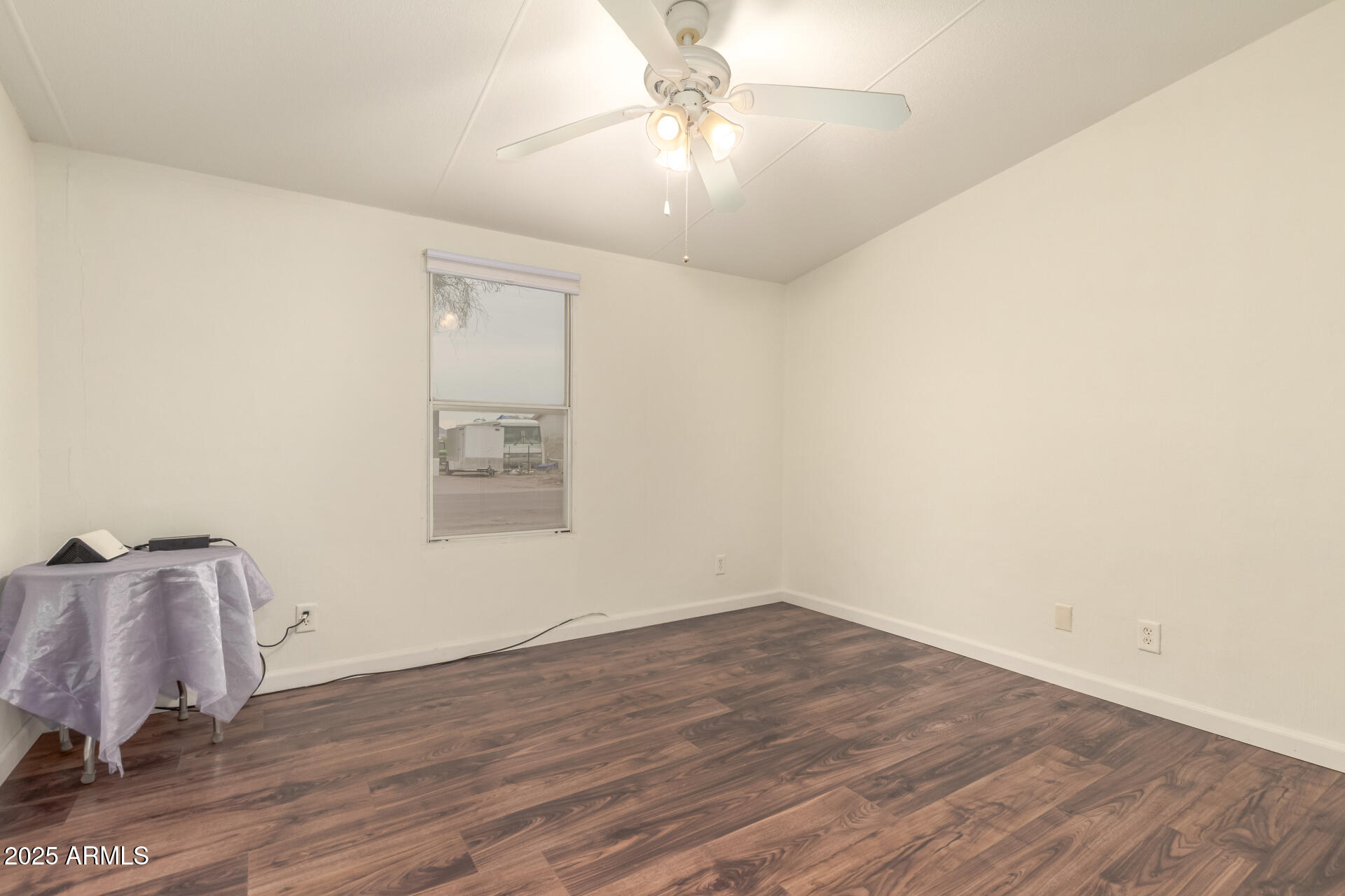 11404 West Custer Road Arizona City, AZ 85123 - Photo 14 of 27 an empty room with wooden floor and windows